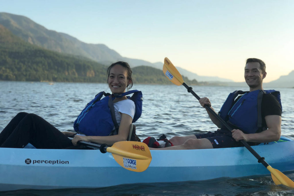 couple paddling a tandem kayak