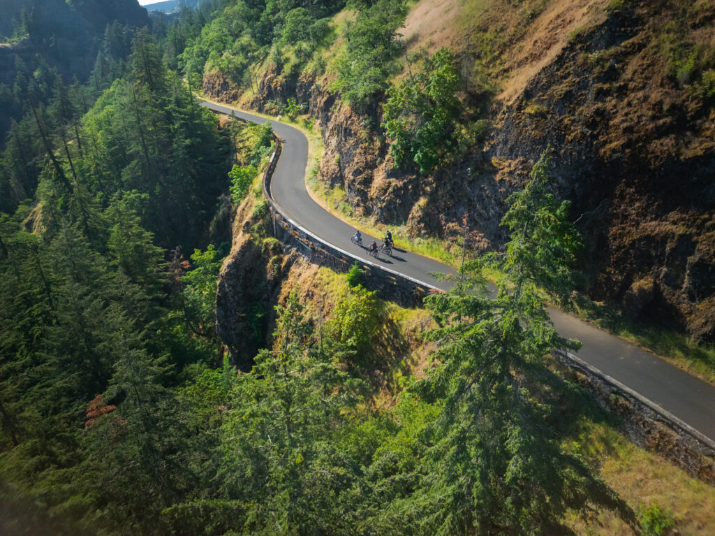 4 E-bike Riders riding near Hood River on the Twin Tunnels section of the Historic Highway with cliffs surrounding them