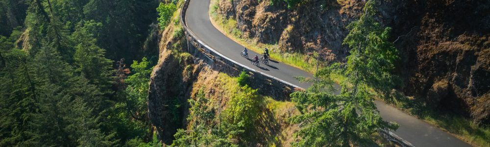 default 4 E-bike Riders riding near Hood River on the Twin Tunnels section of the Historic Highway with cliffs surrounding them
